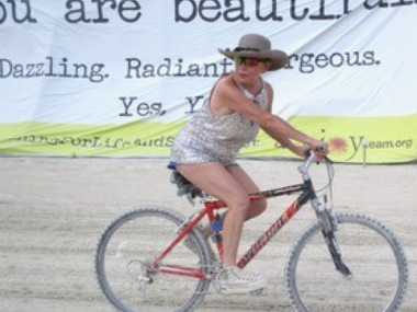 Donna riding a bicycle at Burning Man 2016